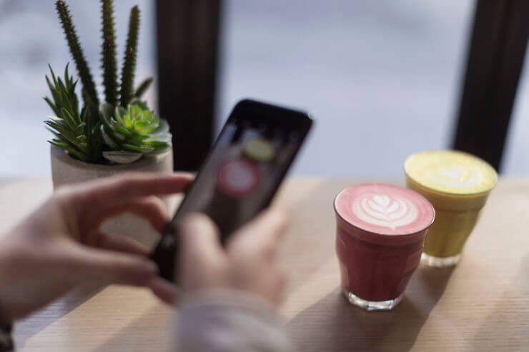Person capturing the Beet Latte on their phone 