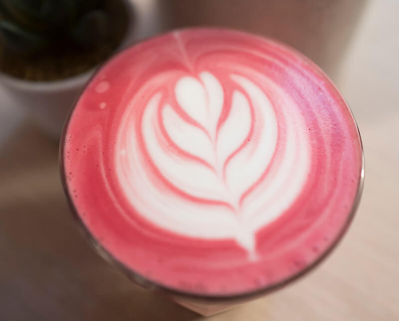 Bluestone Lane Beet Latte with tulip latte art 