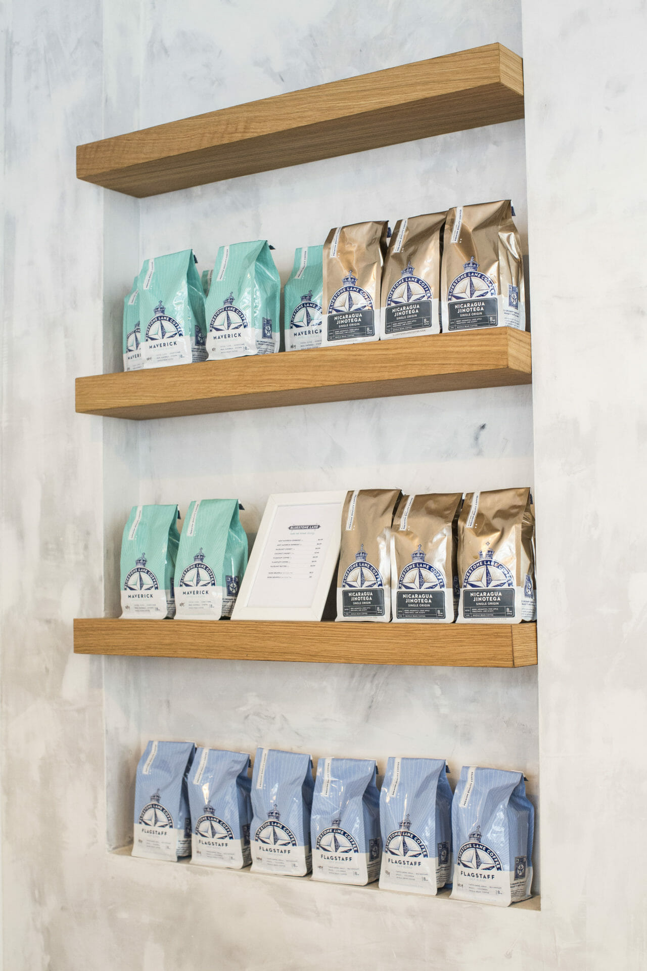 retail coffee shelf with Bluestone Lane retails bags.
