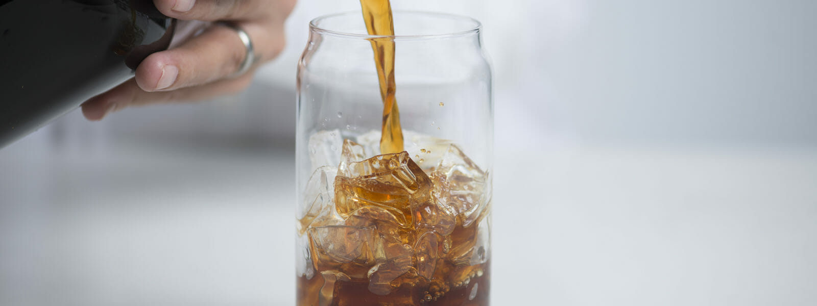 Cold Brew being poured into a glass.