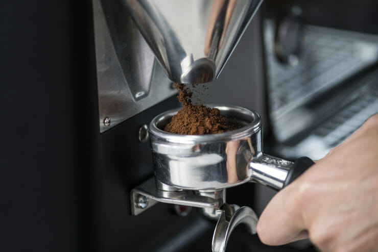 grinder grinding espresso into the group head. 