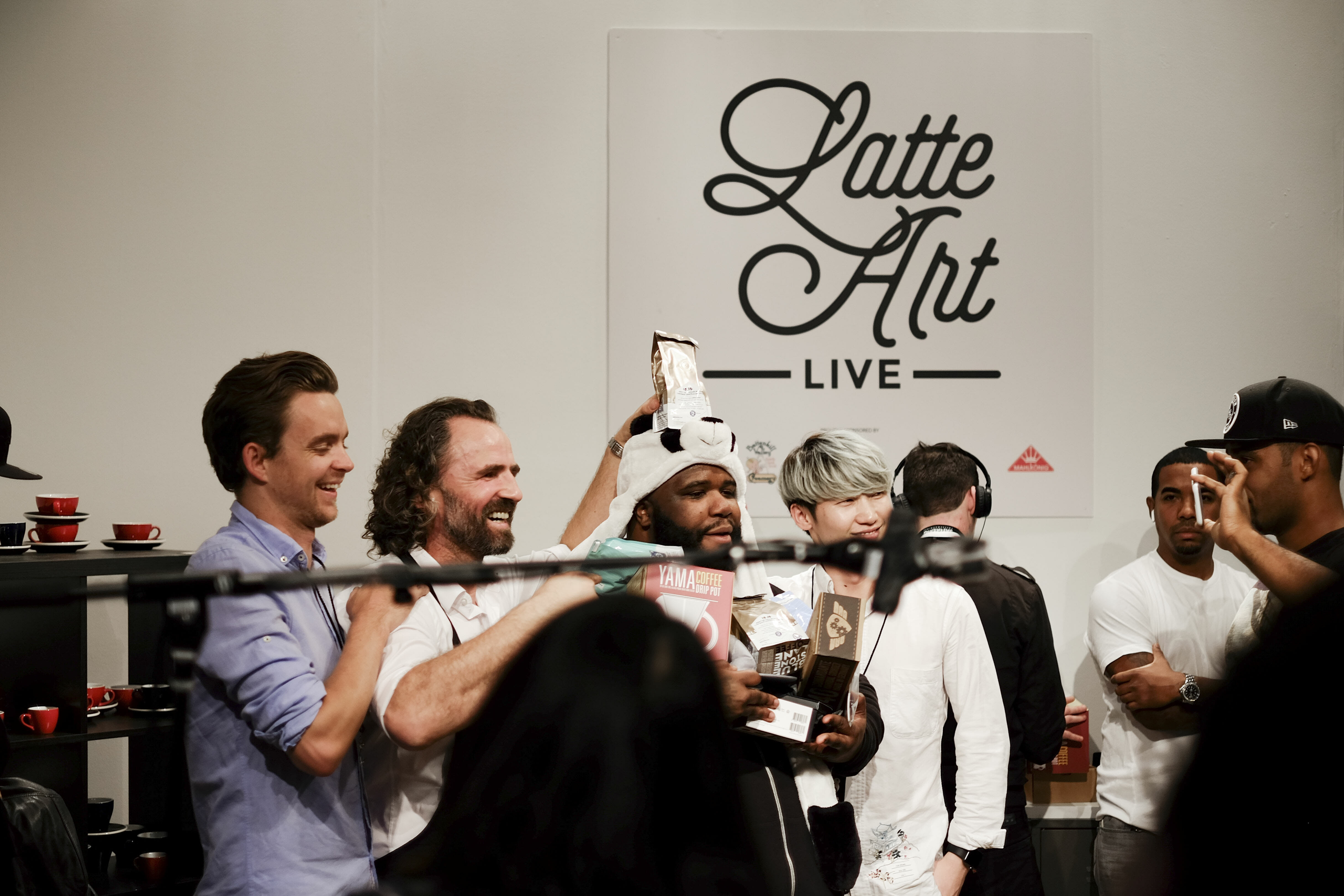 Jai Lott celebrating with winners of the live latte art competition.