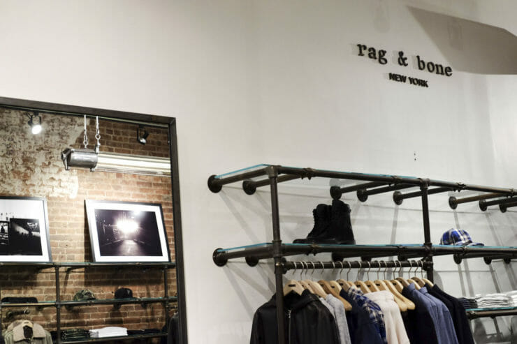 clothing rack in rag and bone with rag and bone logo in background. 