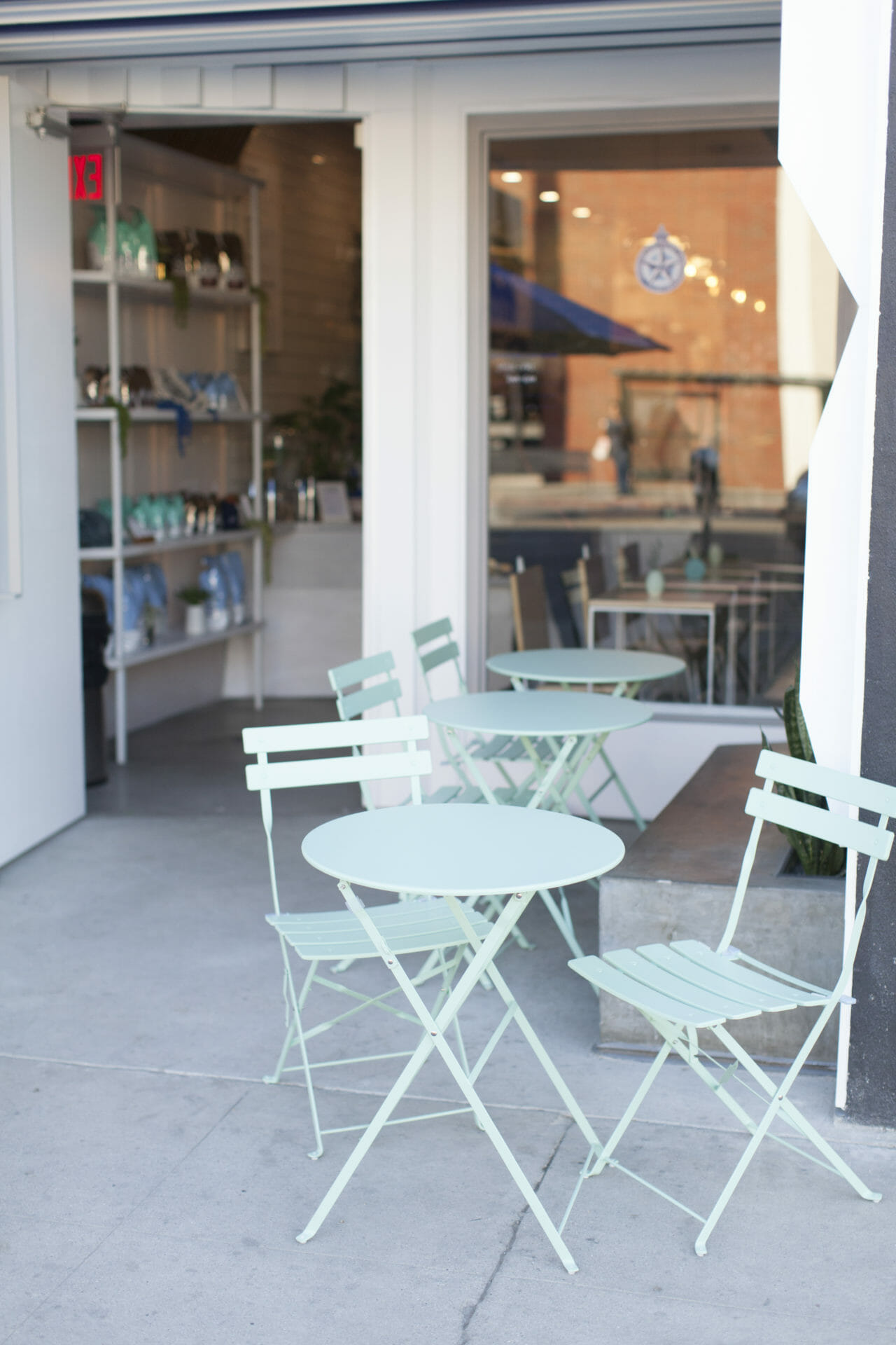 exterior shot with teal tables and chairs.