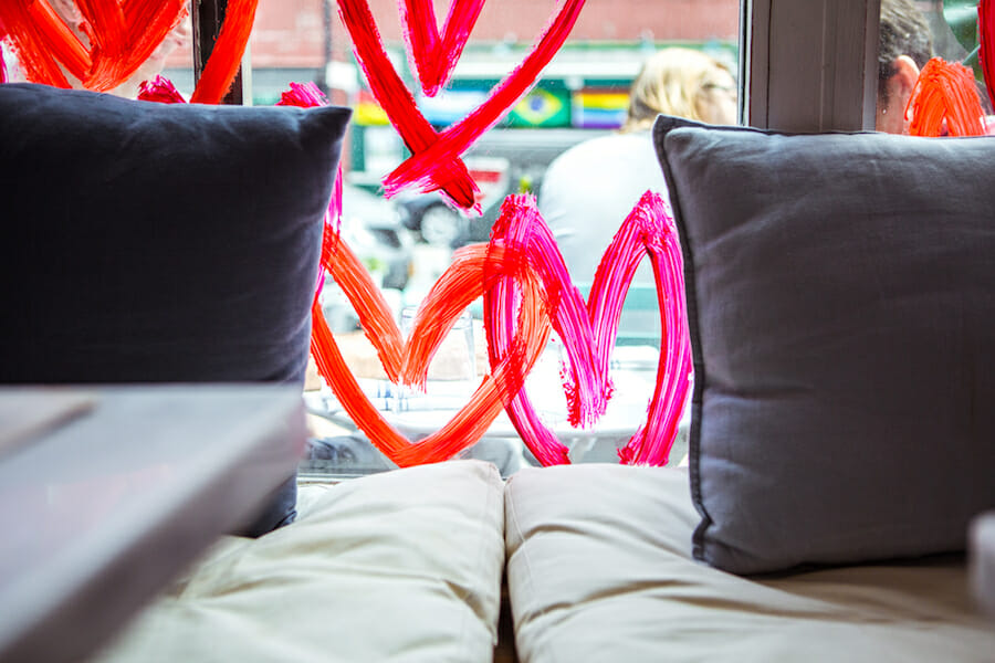 Hearts on the window showing between two cushions