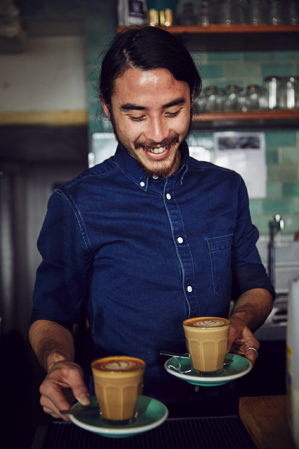 Man holding two coffees