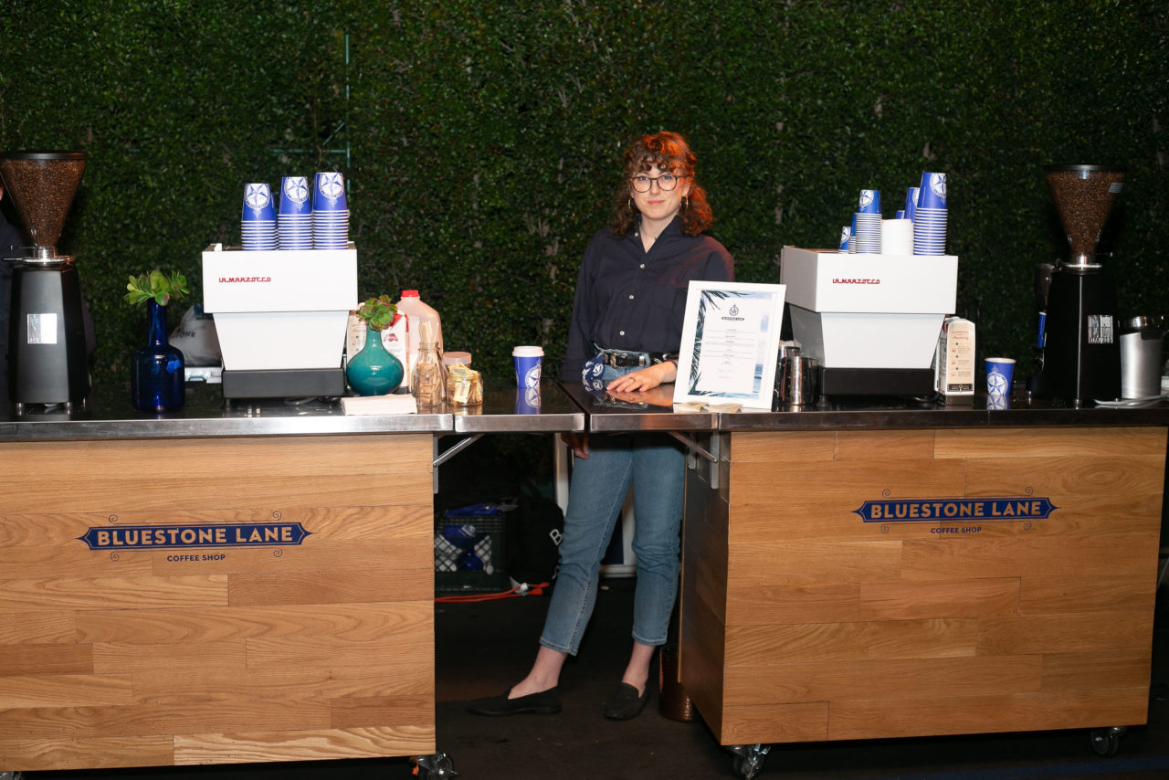 Coffee cart at G'Day USA Gala with female standing behind machine