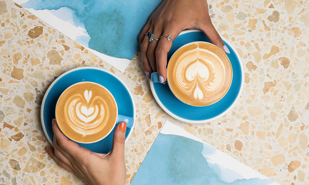 Two flat whites sitting on a table at Bluestone Lane's new Hudson Yards
