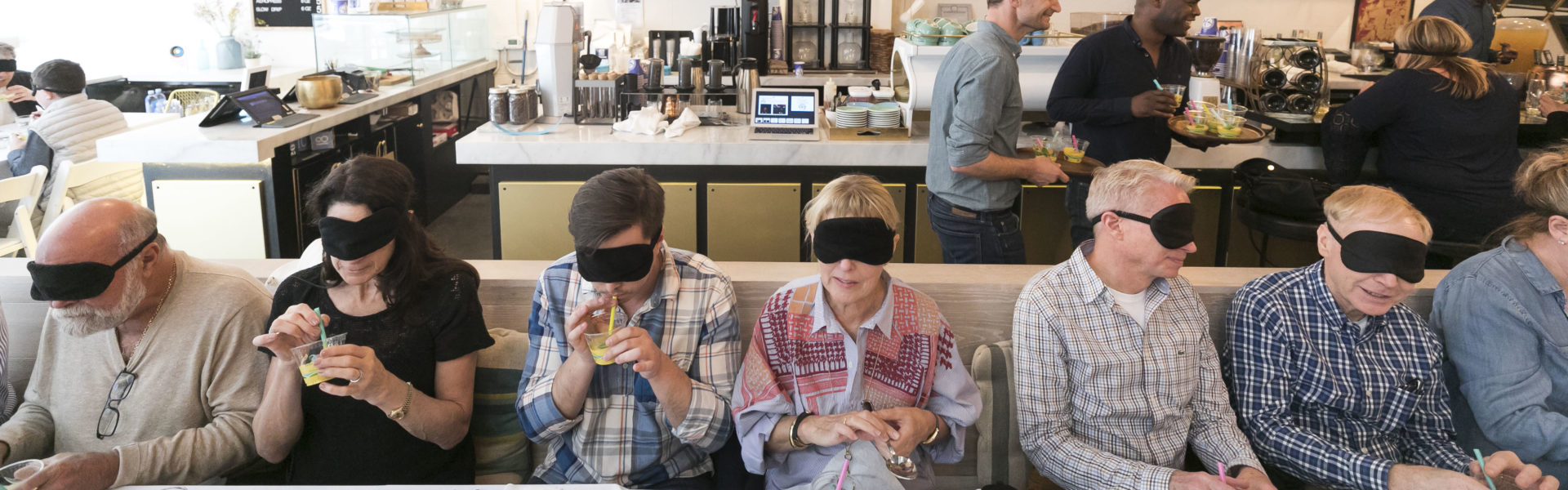 Men & women dining with blindfolds