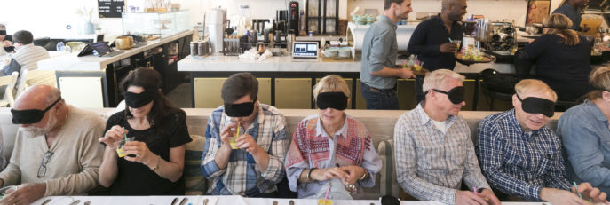 Men & women dining with blindfolds
