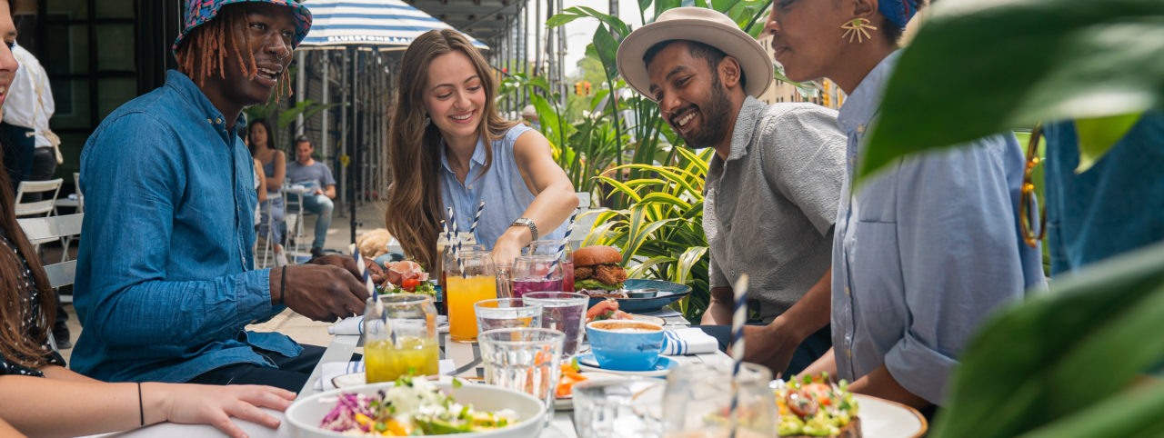 An event with a group of people smiling and enjoying brunch