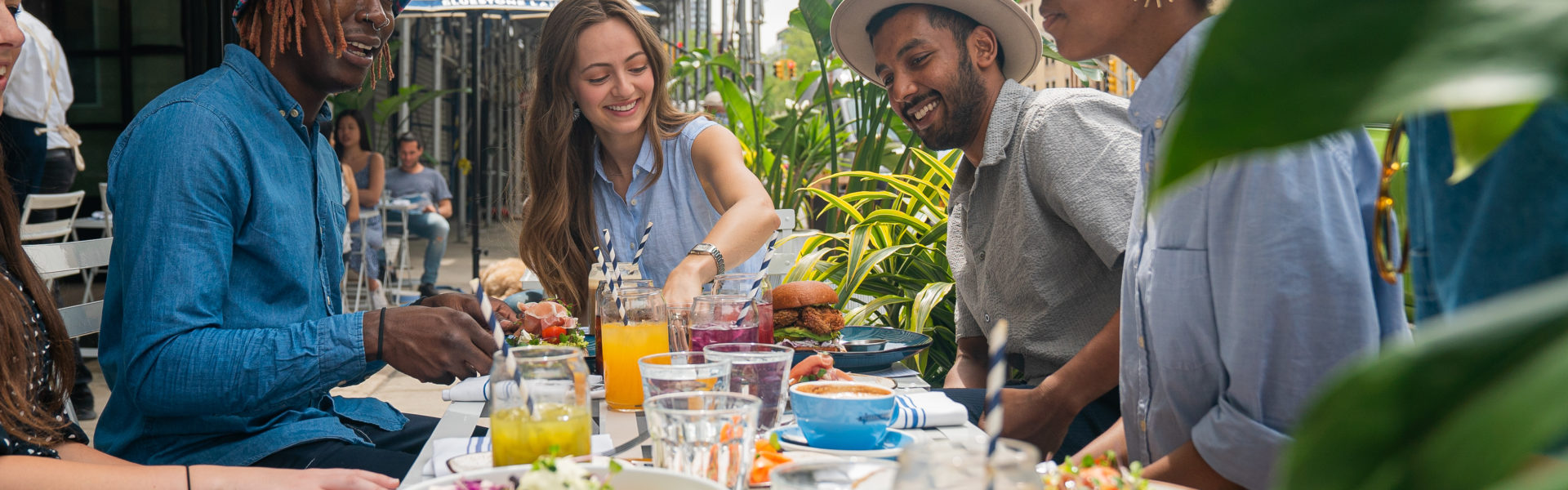 An event with a group of people smiling and enjoying brunch