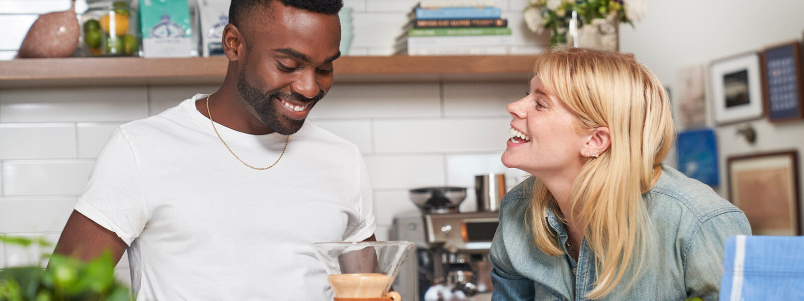 Two people smiling at each other in a kitchen